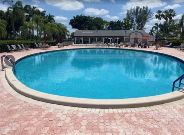 Large community pool with a refreshed bright blue finish